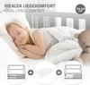 A young girl sleeping peacefully in a bed, with diagrams illustrating the bed's components and dimensions. Produktbild-Vorschau