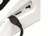 A close-up view of the ports and a connected USB cable on the back of a white electronic device. Produktbild-Vorschau