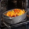 A roasting pan with two cooked chickens and potatoes inside an oven. Produktbild-Vorschau