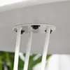 Underside of a round white table with three white hairpin legs attached with black fasteners. Produktbild-Vorschau