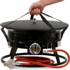 A hand holding straps to lift a black gas fire pit with a red hose and regulator attached. Produktbild-Vorschau