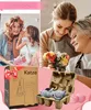 A collage of images showing a mother and daughter exchanging gifts, two women with flowers, and a product box with a cat figurine inside. Produktbild-Vorschau
