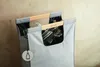 A close-up shot of a grey recycling bag with wooden handles, containing glass bottles. Náhľad obrázku produktu