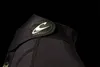 A close-up of a black wetsuit with a logo. Podgląd zdjęcia produktu