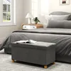 A bedroom scene with a bed, nightstand, and a storage bench in the foreground. Anteprima dell’immagine prodotto