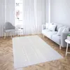 A living room scene with a sofa, chair, and rug. Podgląd zdjęcia produktu