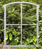 A gray metal window frame is placed in front of lush green foliage. Produktbild-Vorschau