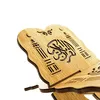 A close-up, angled view of a wooden bookstand with Arabic calligraphy carved into it. Produktbild-Vorschau