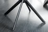 Close-up of the black metal legs of a chair on a wooden floor. Produktbild-Vorschau