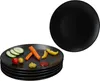 A stack of black plates with some vegetables and condiments on the top plate, and another black plate in the background. Produktbild-Vorschau