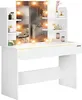 A white vanity table with a lighted mirror and shelves, displaying various cosmetic items. Anteprima dell’immagine prodotto