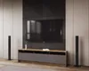 A modern living room setup featuring a TV stand with a television and speakers. Náhľad obrázku produktu