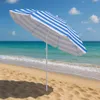 A beach umbrella on a sandy beach with the ocean and sky in the background. Náhled obrázku produktu