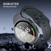 A smartwatch with a protective case is shown against a dark, rocky background with shards of rock flying around it. Produktbild-Vorschau