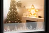 A decorated window with a Christmas tree, a star lamp, and a festive window border. Produktbild-Vorschau