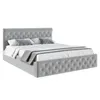 A grey upholstered bed with a tufted headboard and footboard, shown with white and grey bedding and pillows. Produktbild-Vorschau