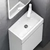 A modern white bathroom sink and vanity with a mirrored cabinet above. Voir les images du produit