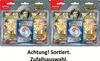 Two Pokémon trading card booster packs with a coin and a card back shown. Produktbild-Vorschau