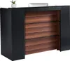 A reception desk with a wooden front and black sides, with a small plant and a computer monitor on top. Anteprima dell’immagine prodotto