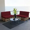 A balcony setting with two pallet sofas and a coffee table, overlooking the ocean. Voir les images du produit