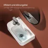 A modern white ceramic sink with water swirling down the drain, reflected in a mirror above. The background is a warm brown. Anteprima dell’immagine prodotto