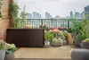 A storage box on a balcony with plants and a city view. Podgląd zdjęcia produktu