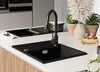 A modern kitchen sink with a black granite basin and a black faucet, set on a white countertop. Produktbild-Vorschau