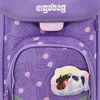 A close-up view of a purple backpack with a pattern of curved lines and polka dots. A decorative patch with two horses is attached to the front pocket. Produktbild-Vorschau