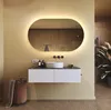 A modern bathroom with a vanity, sink, mirror, and laundry basket. Produktbild-Vorschau