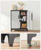 A storage cabinet with doors open, showing shelves with books and decorative items. The bottom section shows close-ups of the cabinet's adjustable feet. Náhled obrázku produktu