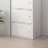 A white cabinet with three drawers is shown in a room with a plant and wooden floor. Produktbild-Vorschau