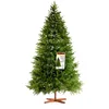 A full shot of a green artificial Christmas tree on a wooden stand, with a tag attached to one of its branches.