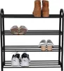 A black metal shoe rack with four shelves, displaying various types of footwear on each shelf. Produktbild-Vorschau