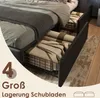 A bed frame with storage drawers pulled out, showing folded blankets inside. Náhled obrázku produktu