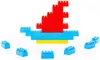 A construction of colorful building blocks arranged to resemble a boat with a sail. Voir les images du produit