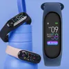 Three fitness trackers are displayed against a blue background, with one tracker prominently featured on the right. Produktbild-Vorschau