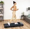 A woman is using a treadmill in a home gym setting. Náhled obrázku produktu