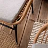 A close-up view of outdoor furniture, including a chair and a table, on a wooden deck. Náhled obrázku produktu