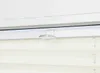 A close-up view of a window blind with a clear plastic clip attached to the top frame. Produktbild-Vorschau