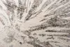 A close-up view of a rug with a modern abstract pattern. Voir les images du produit