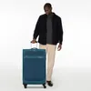A man standing next to a suitcase. Anteprima dell’immagine prodotto