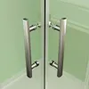 Close-up of two silver shower door handles on a green glass shower enclosure. Produktbild-Vorschau