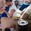 A woman and a child are sitting on a couch. A humidifier is in the foreground. Produktbild-Vorschau
