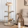 A cat tree with two cats is placed in a living room setting next to a sofa. Podgląd zdjęcia produktu