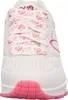 A close-up front view of a white Skechers sneaker with pink heart patterns on the laces. Voir les images du produit