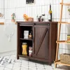 A dark brown wooden sideboard with a sliding barn door, placed in a kitchen setting with white tiled walls and a patterned floor. Podgląd zdjęcia produktu
