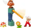 A collection of Super Mario figures and accessories arranged in a diorama-like setting, with a Goomba figure launching fireballs. Produktbild-Vorschau
