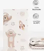 A folded fitted sheet with a space-themed pattern featuring bears in astronaut helmets, rockets, and planets, next to informational icons about material and washing instructions. Produktbild-Vorschau