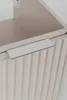 A close-up shot of a cabinet door with a ribbed texture and a silver handle. Produktbild-Vorschau
