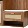 A close-up view of a wooden furniture piece with a white cushion on top, a drawer with a gold handle, and a woven panel. Produktbild-Vorschau